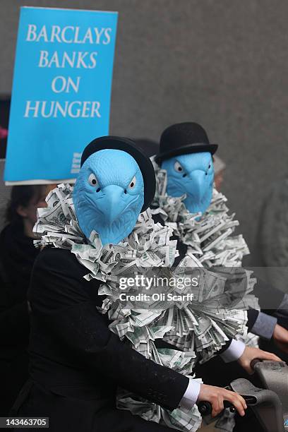 Protesters dressed as suited eagles on Barclays cycle hire bikes demonstrate outside the Royal Festival Hall which is hosting the Barclays bank AGM...