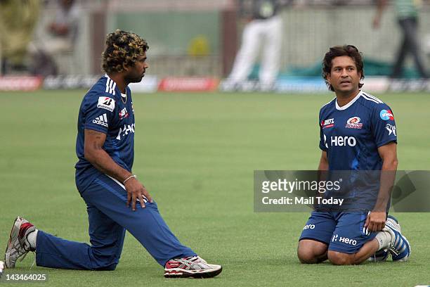Mumbai Indians player Sachin Tendulkar with Lasith Malinga during a practice session a day before the IPL-5 match against Delhi Daredevils at...