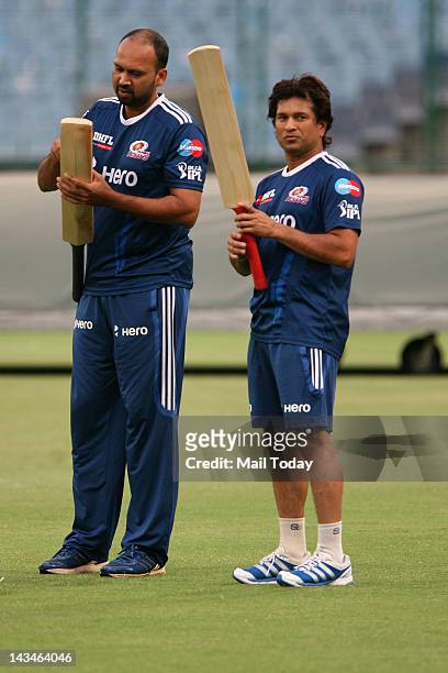 Mumbai Indians player Sachin Tendulkar with batting coach Pravin Amre during a practice session a day before the IPL-5 match against Delhi Daredevils...
