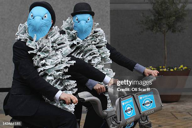 Protesters dressed as suited eagles on Barclays cycle hire bikes demonstrate outside the Royal Festival Hall which is hosting the Barclays bank AGM...