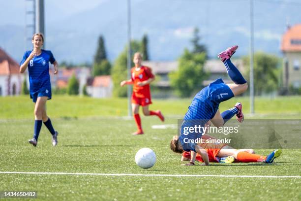 female football players falling on pitch - football pitch bildbanksfoton och bilder