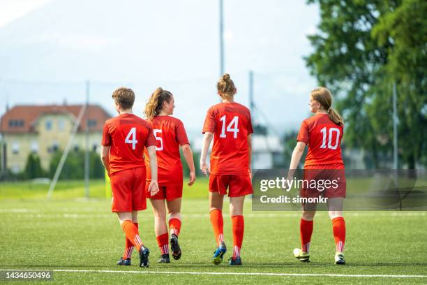 female players walking on pitch - uniform stock pictures, royalty-free photos & images