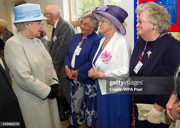 Queen Elizabeth II chats with parents bereaved by the 1966 Aberfan disasster, Marjorie Collins, Elaine Morgan and Jean Gough, during her visist to...