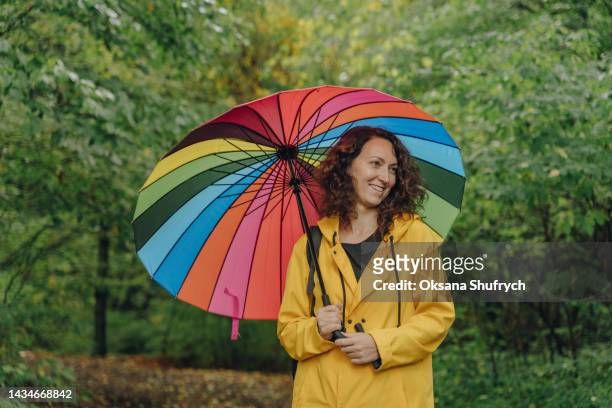 woman walk in the forest under umbrella - landscap with rainbow fotografías e imágenes de stock