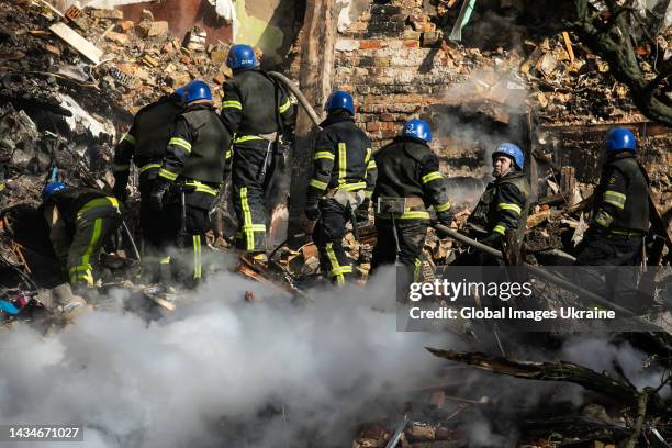 Firefighters are conducting search and rescue operations at residential building hit by kamikaze drone on October 17, 2022 in Kyiv, Ukraine. Five...