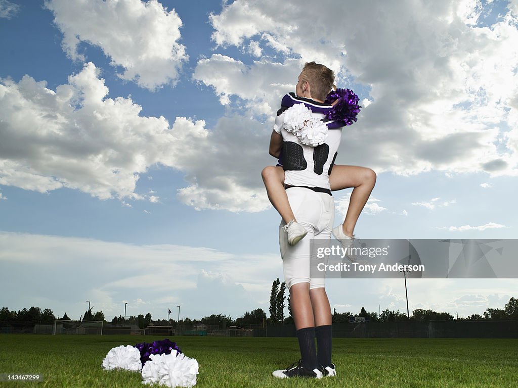 Cheerleader and Footballer Hugging