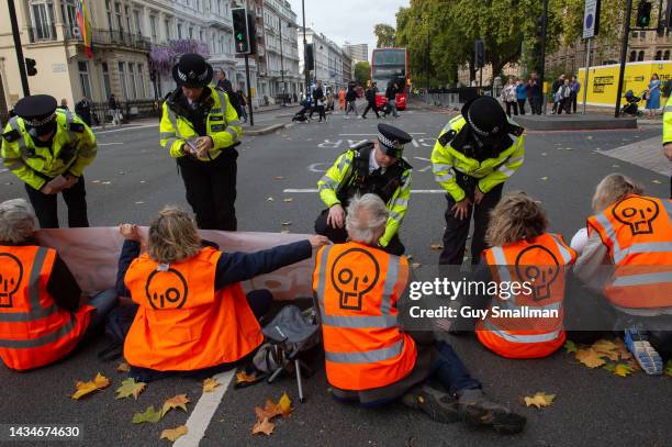 Police arrive on the scene as protestors from Just Stop Oil block the Cromwell road near the Natural History Museum in west London on October 19,...