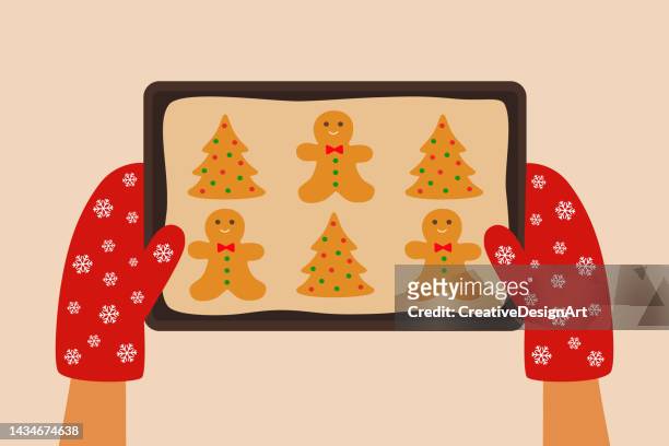 stockillustraties, clipart, cartoons en iconen met high angle view of hands holding baking tray with christmas gingerbread cookies - speculaaskoek