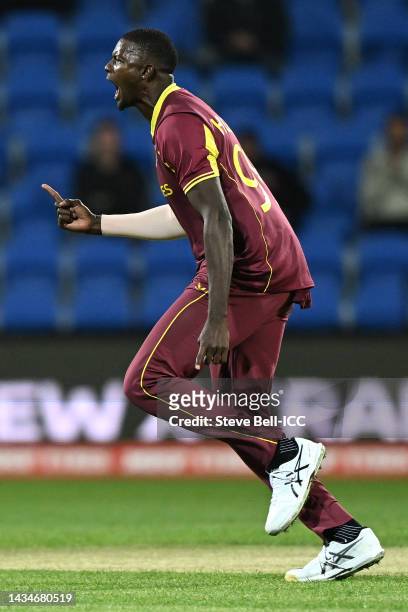 Jason Holder of the West Indies celebrates taking the wicket of Wesley Madhevere of Zimbabwe for 27 runs during the ICC Men's T20 World Cup match...