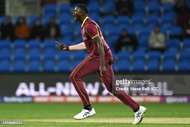 Jason Holder of the West Indies celebrates taking the wicket of Wesley Madhevere of Zimbabwe for 27 runs during the ICC Men's T20 World Cup match...