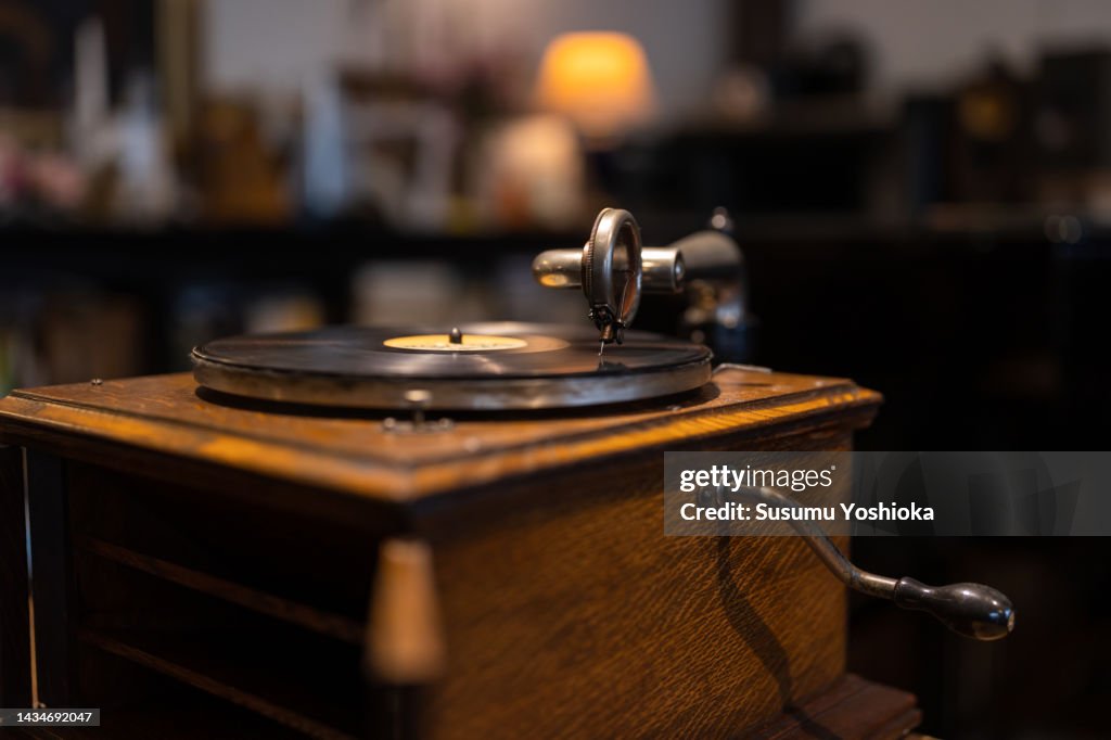 A senior man enjoying analog records in his study.
