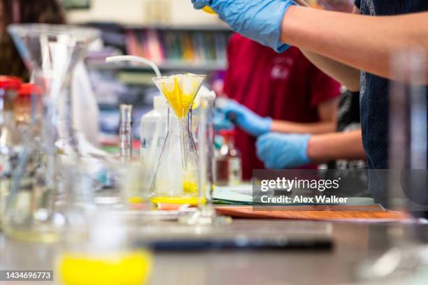 glass test tubes and equipment in a science lab. - cambridge institute laboratory stock pictures, royalty-free photos & images