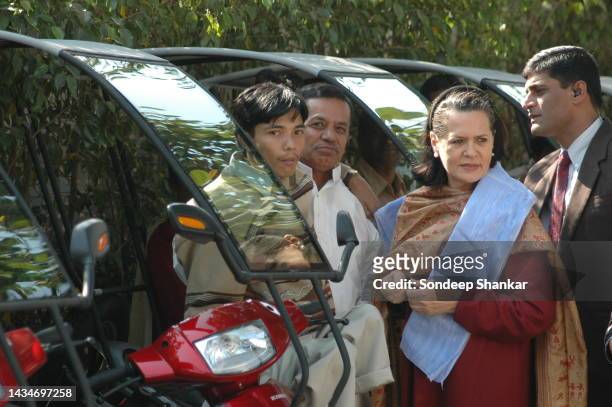 Congress President Sonia Gandhi handing over keys of three wheeler autos to physically impaired persons on the World Disabled Day in New Delhi.