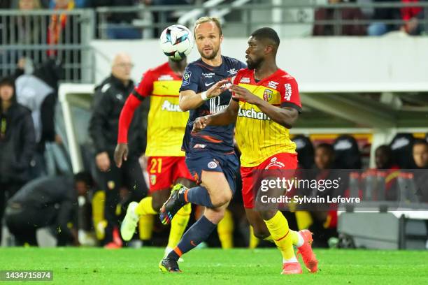 Valere Germain of Montpellier competes for the ball with Kevin Danso of RC Lens during the Ligue 1 Uber Eats match between Lens and Montpellier at...