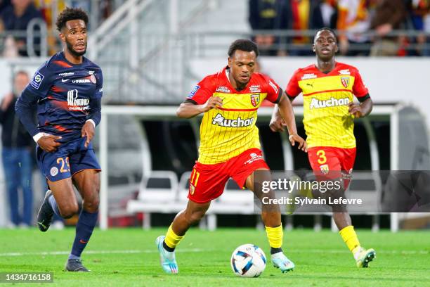 Enzo Gianni Tchato Mbiayi of Montpellier and Lois Openda of RC Lens compete during the Ligue 1 Uber Eats match between Lens and Montpellier at Stade...