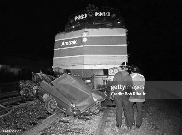 Crushed and charred automobile remains on train tracks after being struck and dragged by an Amtrak passenger train, February 7, 1982 in Commerce,...