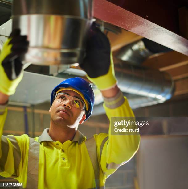 air conditioning  installer - pipes and ventilation stock pictures, royalty-free photos & images