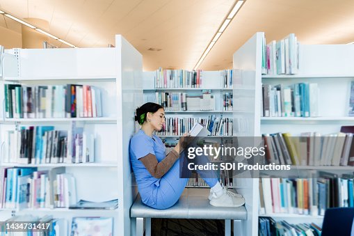 Female intern finds quiet spot in library to study Female intern finds quiet spot in library to study