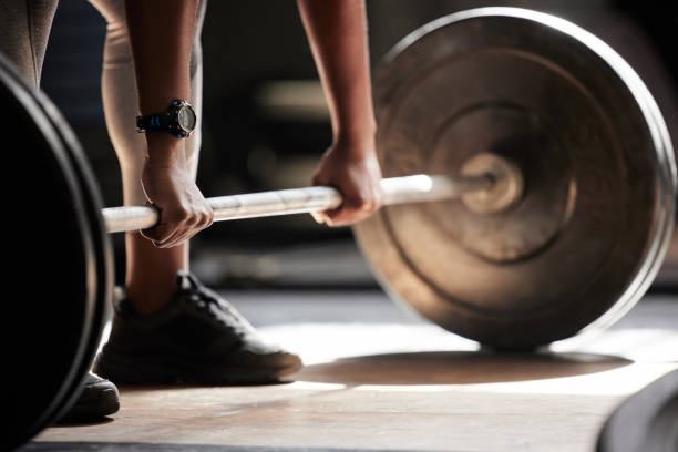 barbell deadlift hands, strong fitness and power of black woman, athlete and bodybuilder in gym, sports workout and exercise. closeup floor start, healthy muscle training and heavy challenge lifting - powerlifting stock pictures, royalty-free photos & images