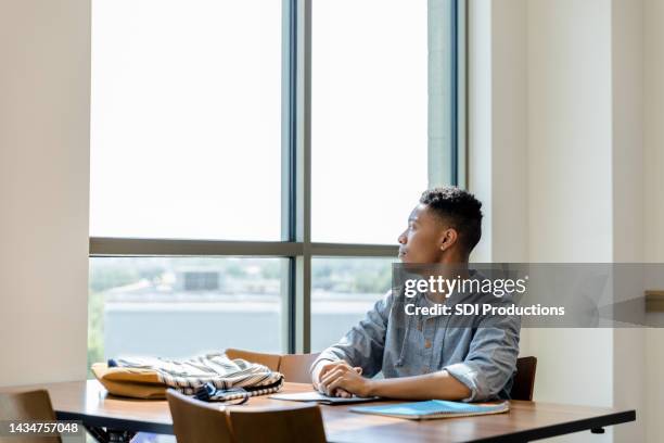 high school student daydreaming - teenage boy looking out window stock pictures, royalty-free photos & images