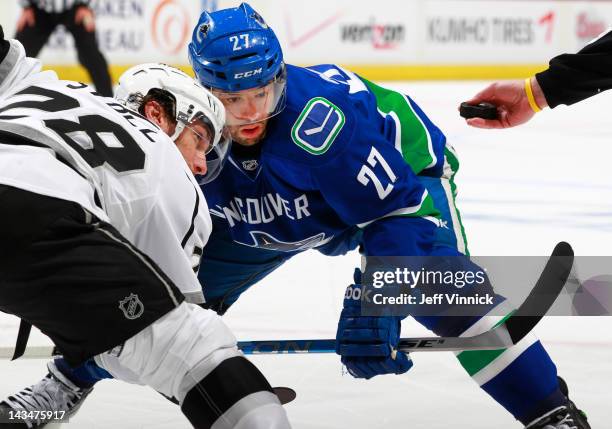 Manny Malhotra of the Vancouver Canucks and Jarret Stoll of the Los Angeles Kings face-off during Game Five of the 2012 NHL Stanley Cup Playoffs at...