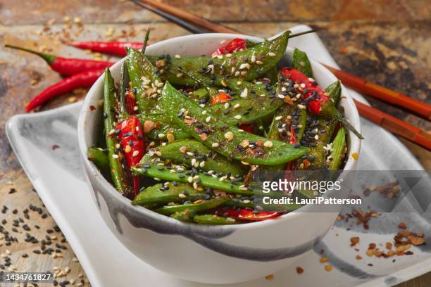 stir fried sesame snap peas and thai chili peppers - sesame oil stock pictures, royalty-free photos & images