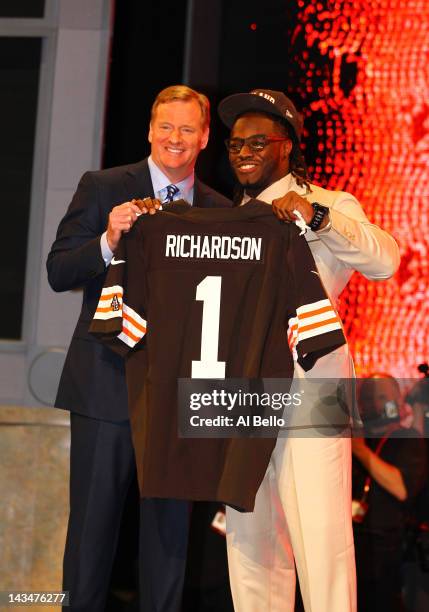 Trent Richardson from Alabama holds up a jersey as he stands on stage with NFL Commissioner Roger Goodell after he was selected overall by the...