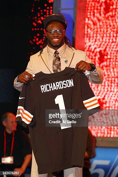 Trent Richardson from Alabama holds up a jersey as he stands after he was selected overall by the Cleveland Browns in the first round of the 2012 NFL...