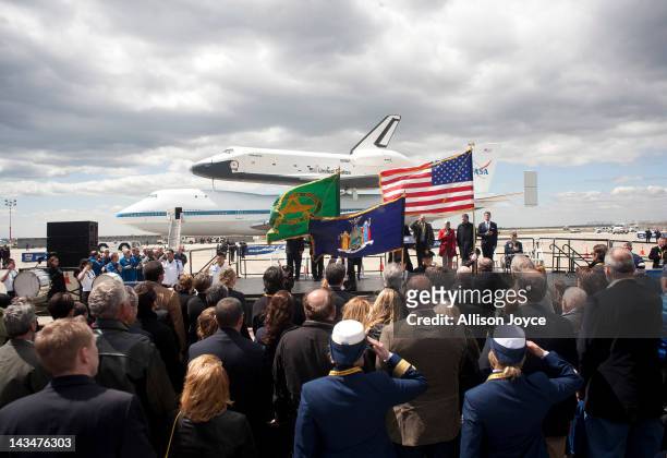 Space shuttle Enterprise, mounted atop a 747 shuttle carrier aircraft, sits on the tarmac during a ceremony at John F. Kennedy International Airport...