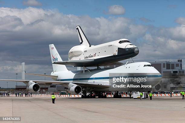 Space shuttle Enterprise, mounted atop a 747 shuttle carrier aircraft, sits on the tarmac during a ceremony at John F. Kennedy International Airport...