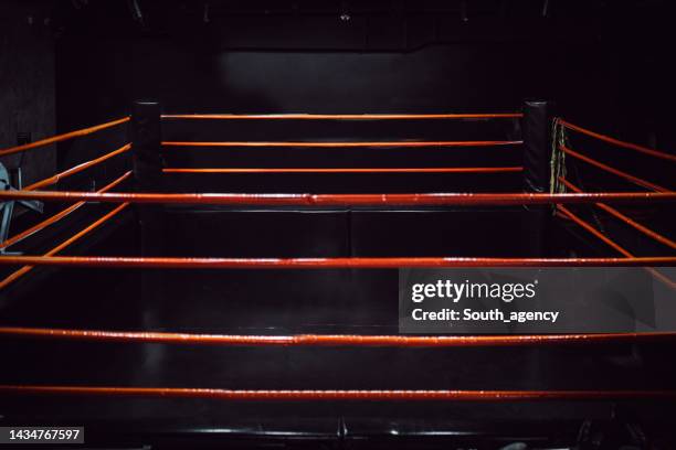 boxing ring in dark gym - boxing ring stock pictures, royalty-free photos & images