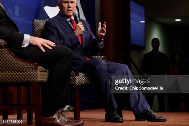 With a knee brace visible through his right pant leg, former Vice President Mike Pence joins Heritage Foundation President Kevin Roberts for an event...