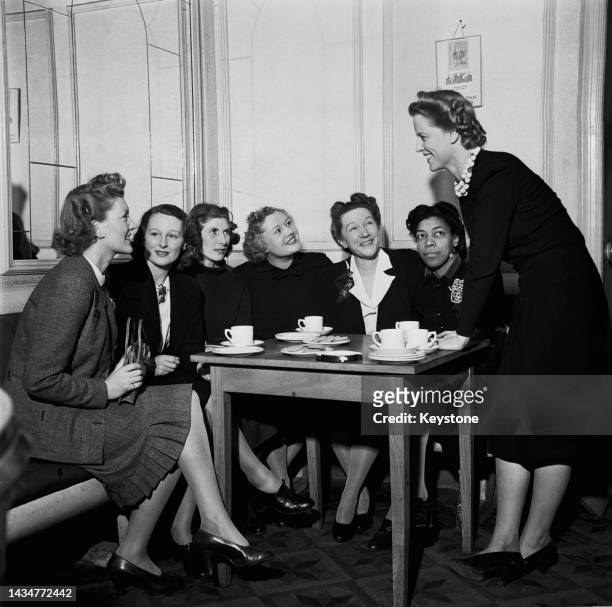 Jamaican journalist, activist and author, Una Marson having tea with a group of women broadcasters in an underground theatre in London, between BBC...