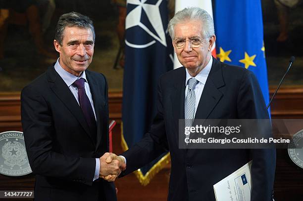 Italian Prime Minister Mario Monti shakes hands with NATO Secretary General Anders Fogh Rasmussen after a press conference at Palazzo Chigi on April...