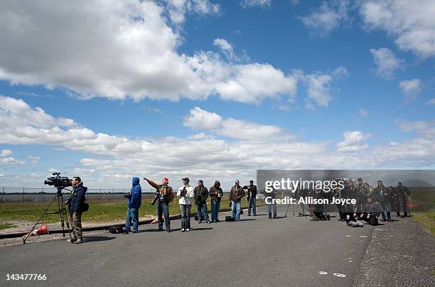 Media waits on the tarmac for the space shuttle Enterprise to land at John F. Kennedy International Airport April 27, 2012 in the Queens borough of...