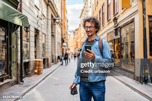 Young Tourist Using A Map On A Smart Phone Young Tourist Using A Map On A Smart Phone
