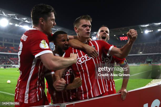 Matthias Ginter of SC Freiburg celebrates scoring their side's first goal with teammates during the DFB Cup second round match between Sport-Club...