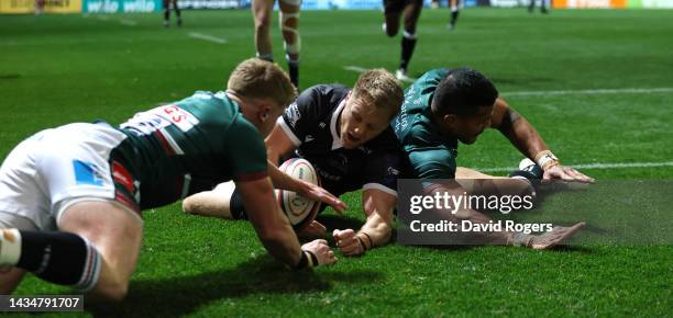 Alex Tait of Newcastle Falcons dives on the loose ball to score their first try during the Premiership Rugby Cup match between Leicester Tigers and...