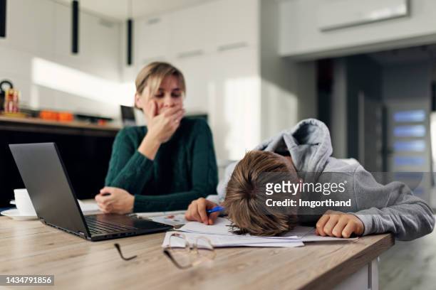 frustrated mother helping frustrated son with some very difficult homework - homework frustration stock pictures, royalty-free photos & images