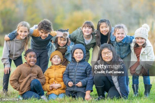 autumn children - autumn friends coats stock pictures, royalty-free photos & images