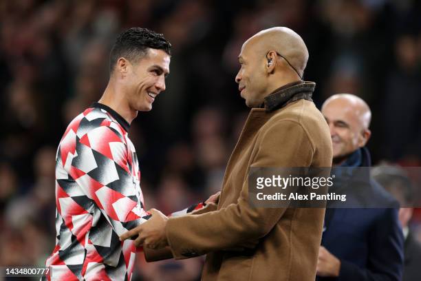 Cristiano Ronaldo of Manchester United interacts with Thierry Henry prior to the Premier League match between Manchester United and Tottenham Hotspur...