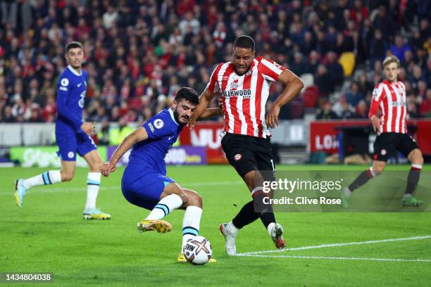 Armando Broja of Chelsea is challenged by Mathias Zanka Jorgensen of Brentford during the Premier League match between Brentford FC and Chelsea FC at...