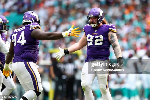 Dalvin Tomlinson of the Minnesota Vikings celebrates with James Lynch after a play during an NFL football game against the Miami Dolphins at Hard...