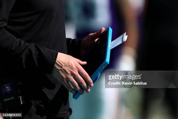 Minnesota Vikings coach holds a Microsoft Surface tablet during an NFL football game against the Miami Dolphins at Hard Rock Stadium on October 16,...