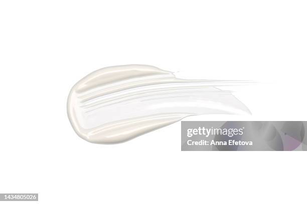 textured cosmetic smear of white cream isolated on white background.  also it can be hyaluronic acid, polyglutamic acid or serum with peptides, ceramides, retinol molecules, aha acid. concept of health and wellbeing. flat lay style with copy space - cream splash stock-fotos und bilder