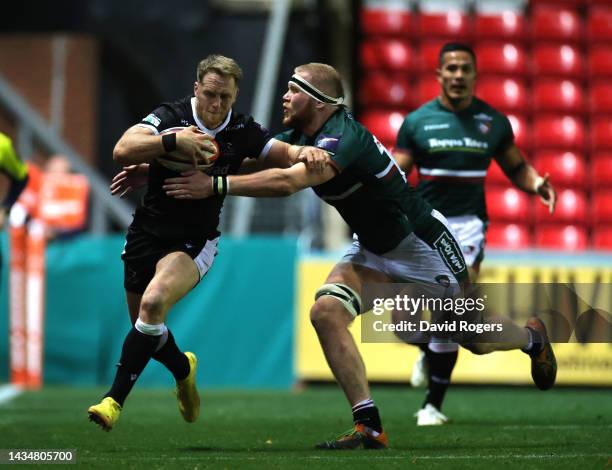 Alex Tait of Newcastle Falcons is tackled by Tom Manz during the Premiership Rugby Cup match between Leicester Tigers and Newcastle Falcons at...