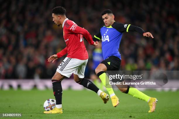 Jadon Sancho of Manchester United is challenged by Cristian Romero of Tottenham Hotspur during the Premier League match between Manchester United and...