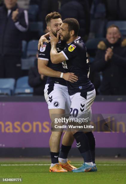 Tom Bradshaw of Millwall is congratulated by m20after scoring his third goal during the Sky Bet Championship between Millwall and Watford at The Den...
