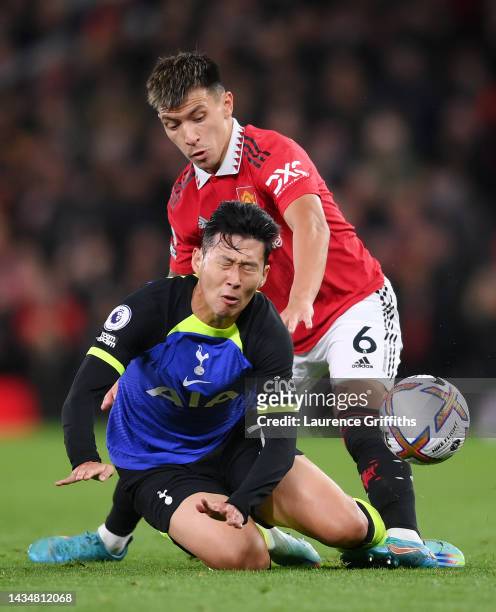 Son Heung-Min of Tottenham Hotspur is challenged by Lisandro Martinez of Manchester United during the Premier League match between Manchester United...