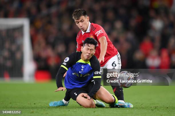 Son Heung-Min of Tottenham Hotspur is challenged by Lisandro Martinez of Manchester United during the Premier League match between Manchester United...